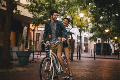 Loving Couple Riding Bicycle On City Road Stock Photo Image Of Female