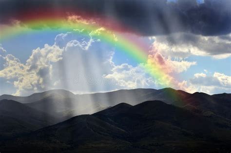 Rays Of Sunlight On Peaceful Mountains And Rainbow Stock Photo Image