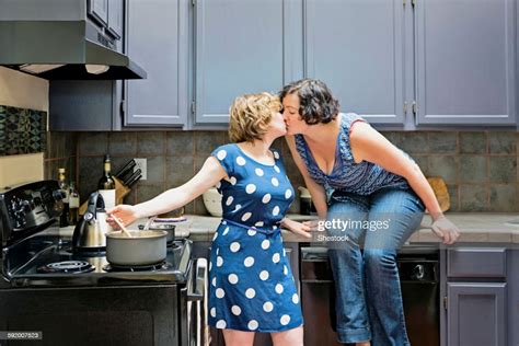 Lesbian Couple Cooking In Kitchen Photo Getty Images