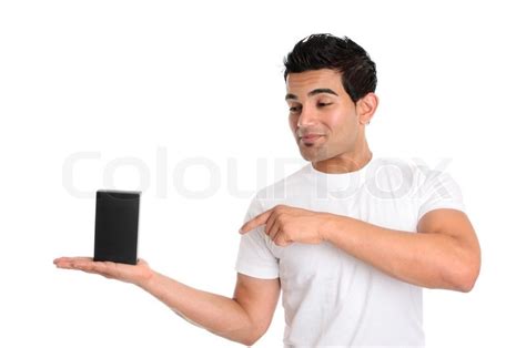 A Guy Holds A Product In The Palm Of His Hand He Is Looking Directly At