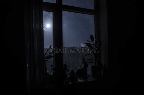 Night Scene Of Moon Seen Through The Window From Dark Room Stock Photo