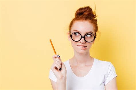 Free Photo Mystery Ginger Woman In Eyeglasses Bites Her Lip With Pencil