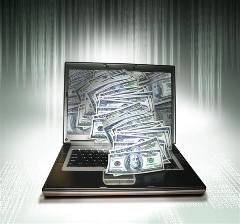 Computer Money A Graphite Pc Laptop With Money Spilling From The