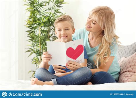 Portrait Of Cute Little Boy And His Mother With Handmade Card In