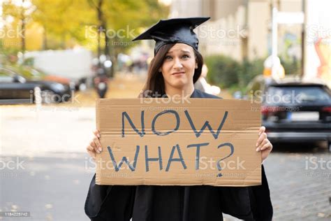 Sad Graduate Student Standing With Now What Placard Stock ...