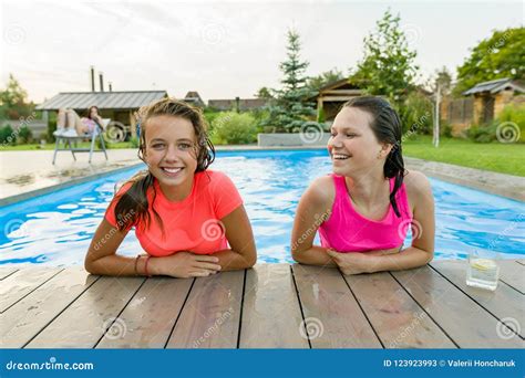 Two Young Teenage Girls Having Fun In The Swimming Pool Stock Image Image Of Happiness Blue