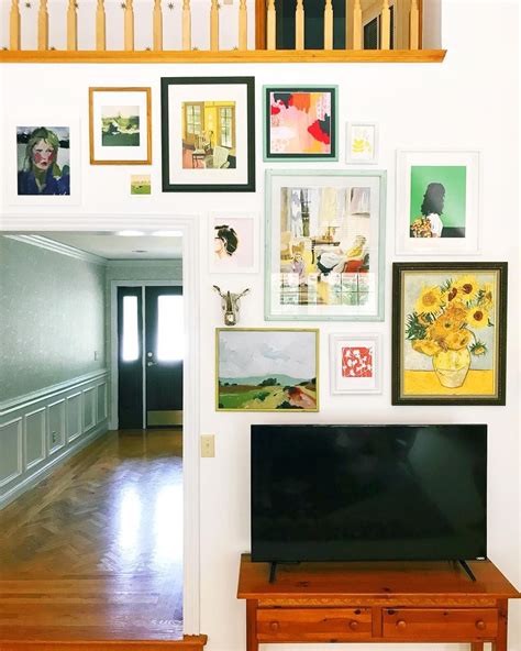This striking gallery walls catches an eye. Gallery wall above the TV | Gallery wall, Wall, Home decor