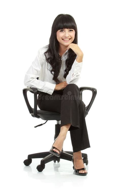 Portrait Of Beautiful Young Woman Sitting On Chair Stock Photo Image