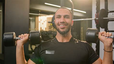 happy smiling african american sportsman doing power exercise at gym with sport equipment