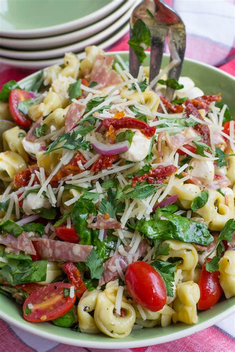 Stir in pasta and tomatoes. Tuscan Tortellini Salad - What the Forks for Dinner?