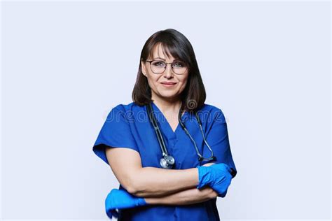 Portrait Of Nurse Doctor Woman Looking At Camera On White Background