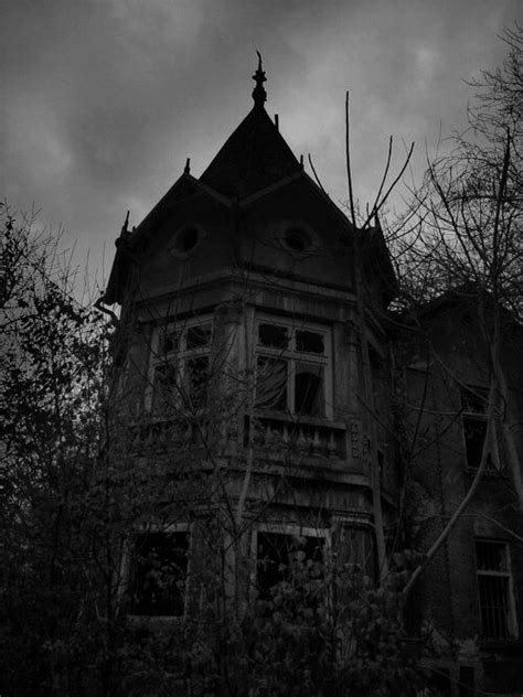 An Old Abandoned House In The Woods At Night With Dark Clouds And Spooky Trees