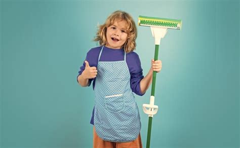 Premium Photo Child Doing Housework Child Use Duster And Gloves For