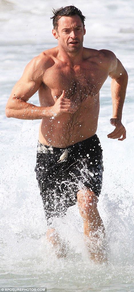 Hugh Jackman Displays Bulging Biceps As He Runs Out Of The Sea Topless