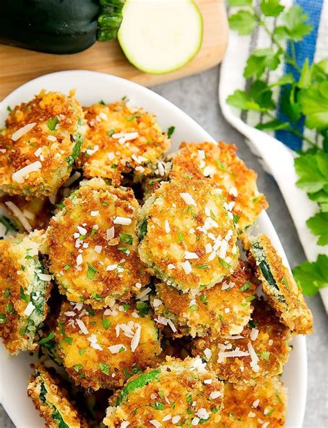 Ingredients 2 zucchini, cut lengthwise in half 1/4 cup shredded parmesan cheese (1 oz) 1 tablespoon olive oil freshly ground pepper to taste 2 tablespoons chopped fresh basil leaves Parmesan Zucchini Crisps - Kirbie's Cravings