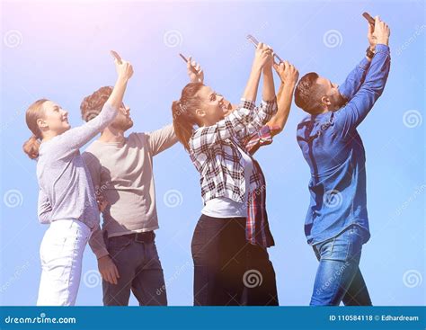 Rear View Happy Friends Doing A Selfie Stock Photo Image Of Online