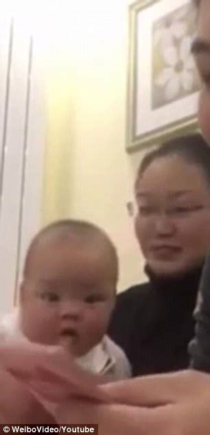Baby Gets A Fit Of The Giggles As She Watches Her Father