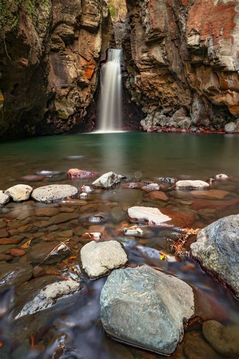 Waterfall Surrounded By Rocks Beautiful Landscape Foreground With