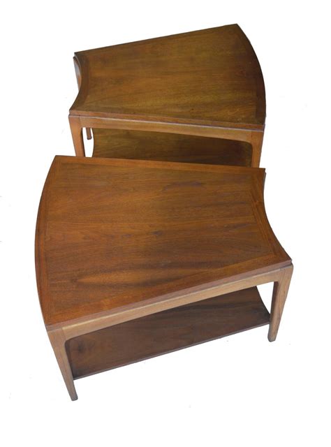 It is heavy to counter balance the swinging tabletop. Pair of Wedge-Shaped the Wave Two-Tier Side Tables For ...
