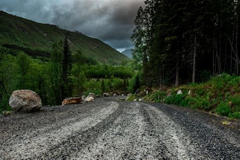 Premium Photo Gravel Road Through Forest And Mountains