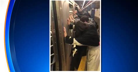 passengers shove subway car to free fellow rider s trapped luggage wheel cbs new york