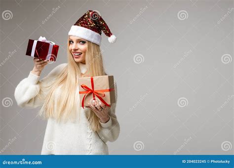 Funny Woman With Christmas Hat Sits With A Big Red Box And Think What Is Inside Picture