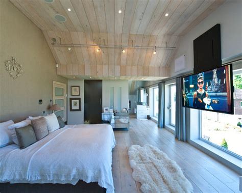 The tv at the end of this bed is hidden inside the actual bed and even has a built in spot for a dvr or blu ray player. Bedroom Tv Home Design Ideas, Pictures, Remodel and Decor