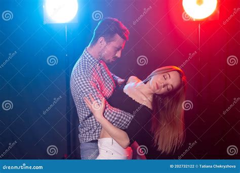 social dance bachata salsa kizomba zouk tango concept man hugs woman while dancing over