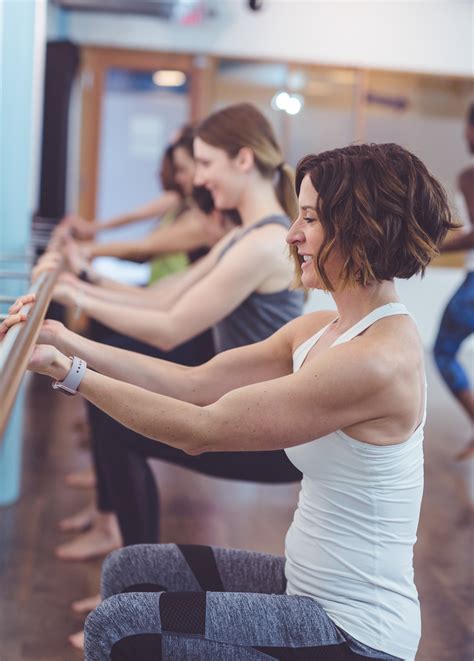Multiethnic Group Of Women Do A Barre Workout Together In A Modern