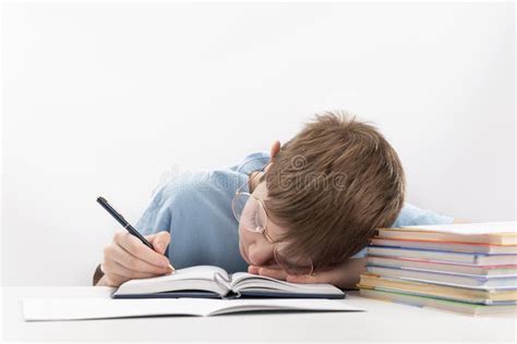Bored And Tired Boy Doing Homework On Desk Schoolboy Fell Asleep On