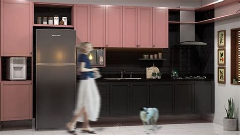 A Woman Is Walking Past A Refrigerator In A Kitchen With Pink Cabinets