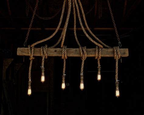 A Chandelier Made Out Of Wood And Rope With Light Bulbs Hanging From It