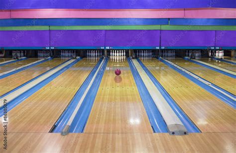Generic Bowling Alley Lanes With Bowling Ball Going Towards The Pins