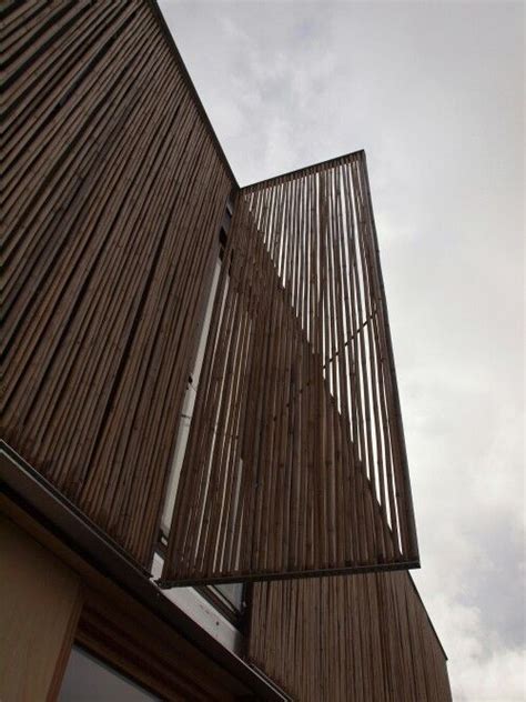 The Side Of A Building With Wooden Slats On Its Sides And A Sky Background