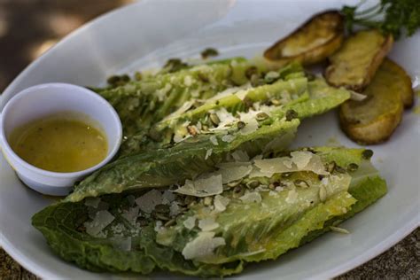 The Tableside Caesar Salad Made Of Romaine Lettuce Parmesan And Toasted Pepitas Served At El D