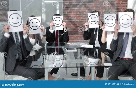 Business Team Keeps Smiley Icons Sitting At The Desk Stock Image
