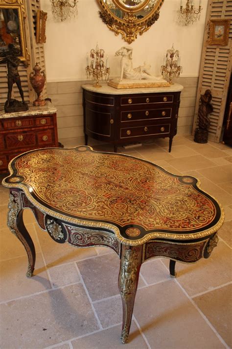 A piece of furniture usually supported by one or more legs and having a flat top surface on which objects can be placed: Table violon en marqueterie Boulle d'époque Napoléon III ...