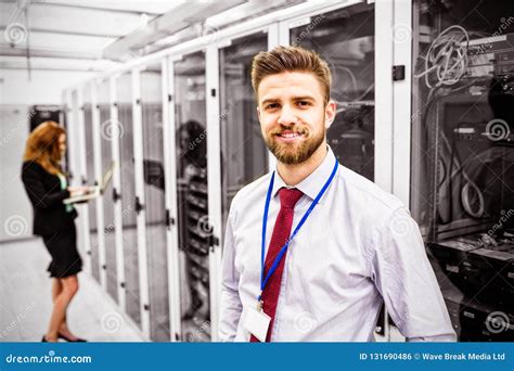 Smiling Technician Standing In A Server Room Stock Photo Image Of