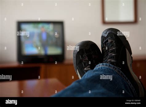 A Person Follows Programme On Tv Tv Television Viewer Legs Relax