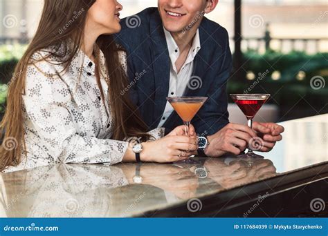 Man And Woman Enjoy The Conversation On A Date On Bar Counter Drinking