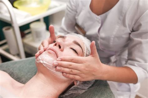 Premium Photo Doctor Beautician Makes Cosmetic Facial Massage Woman