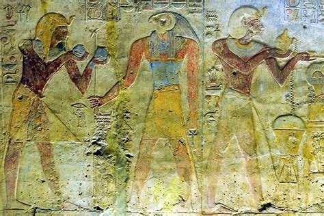 Two Ancient Egyptian Paintings On The Side Of A Wall