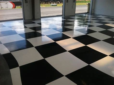 A Black And White Checkered Floor In An Airport Parking Garage With