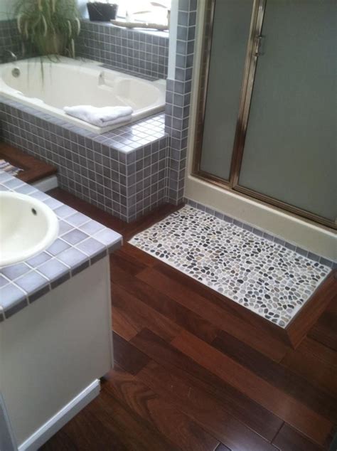 Bath mats have come a long way over the years. master bath. reclaimed teak hardwood floors and pebble ...