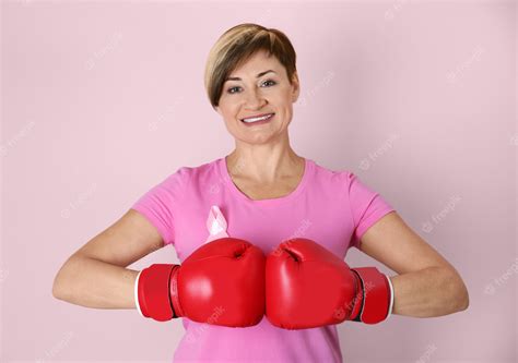 Premium Photo Woman Wearing Boxing Gloves On Color Wall