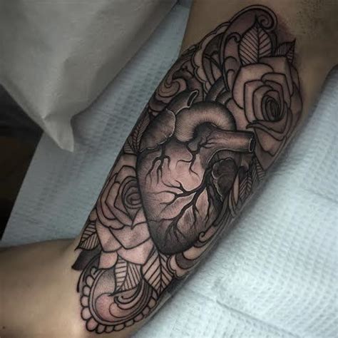 It's a broken heart out of which comes the rose. Anatomical heart with roses tattoo by Laura Jade : Tattoos