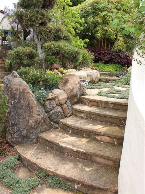 The stones here at how to grow out of the ground, they absolutely fit perfectly in any landscape. like the use of loose stacked stone in contrast to more formal stairs | Hillside garden ...