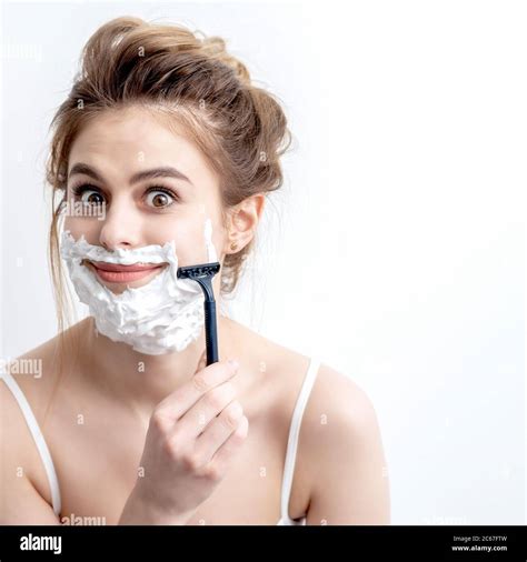 Beautiful Young Caucasian Woman Shaving Her Face By Razor On White