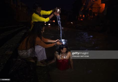Nepali Hindu Women Takes A Ritual Bath In The Bagmati River During