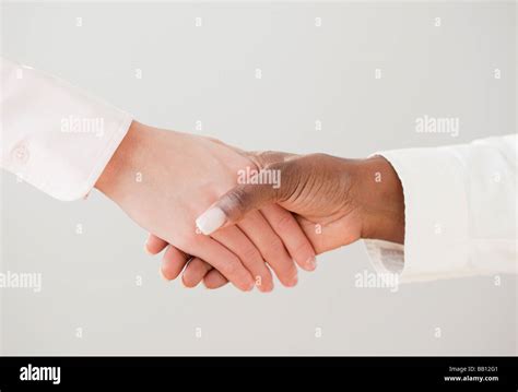 African And Caucasian Woman Shaking Hands Stock Photo Alamy